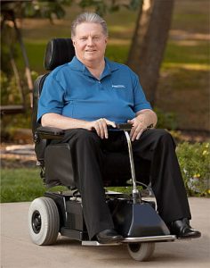 Ralph Braun in a scooter of his design.